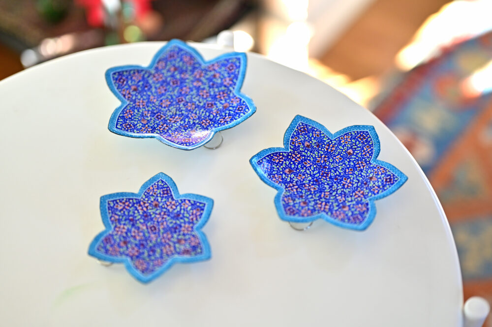 Enhance your home with this set of three Persian copper enamel  (Minakari) star dishes, hand-painted with intricate floral designs in vibrant blue,