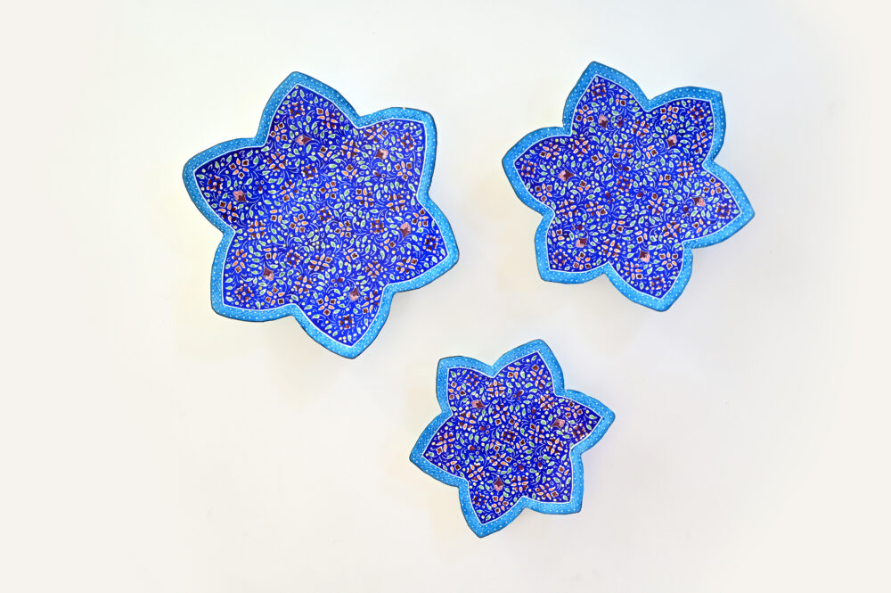 Enhance your home with this set of three Persian copper enamel  (Minakari) star dishes, hand-painted with intricate floral designs in vibrant blue,