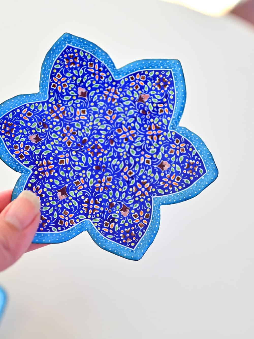 Enhance your home with this set of three Persian copper enamel (Minakari) star dishes, hand-painted with intricate floral designs in vibrant blue,