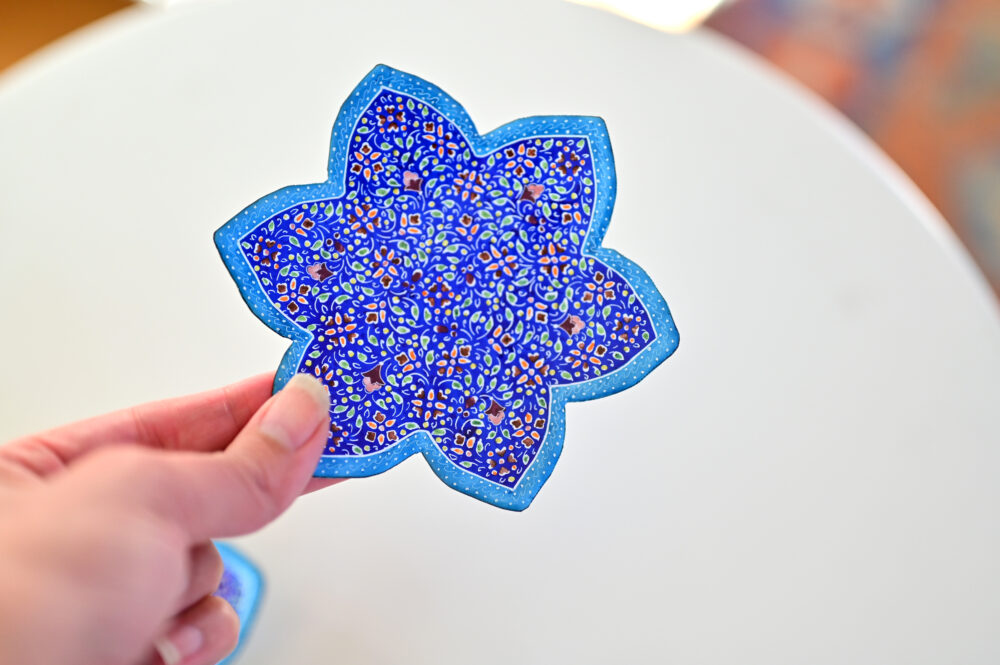 Enhance your home with this set of three Persian copper enamel  (Minakari) star dishes, hand-painted with intricate floral designs in vibrant blue,